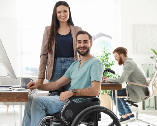 man-on-a-wheelchair-with-office-mates