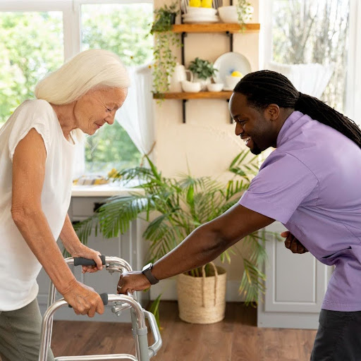 Occupational therapist assisting an elderly woman using a walker in a bright home environment, demonstrating safe mobility support for aging in place