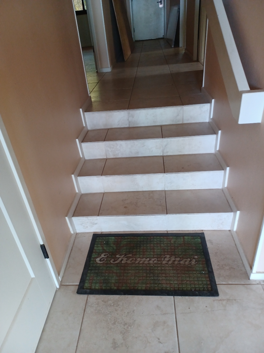 Before FlexStep installation: a closer view of the tiled steps from the lower hallway