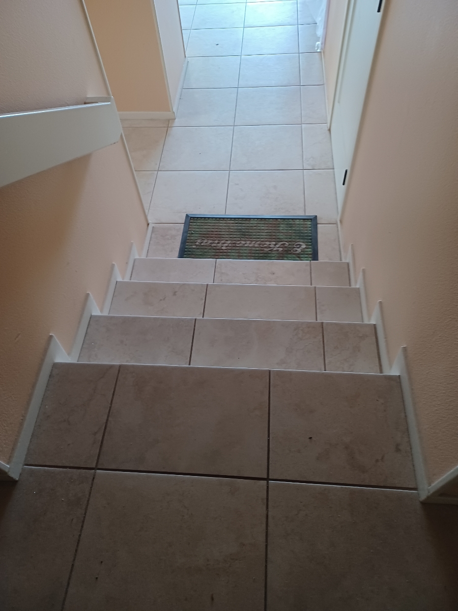 Before FlexStep installation: looking down the original tiled steps from the upper landing