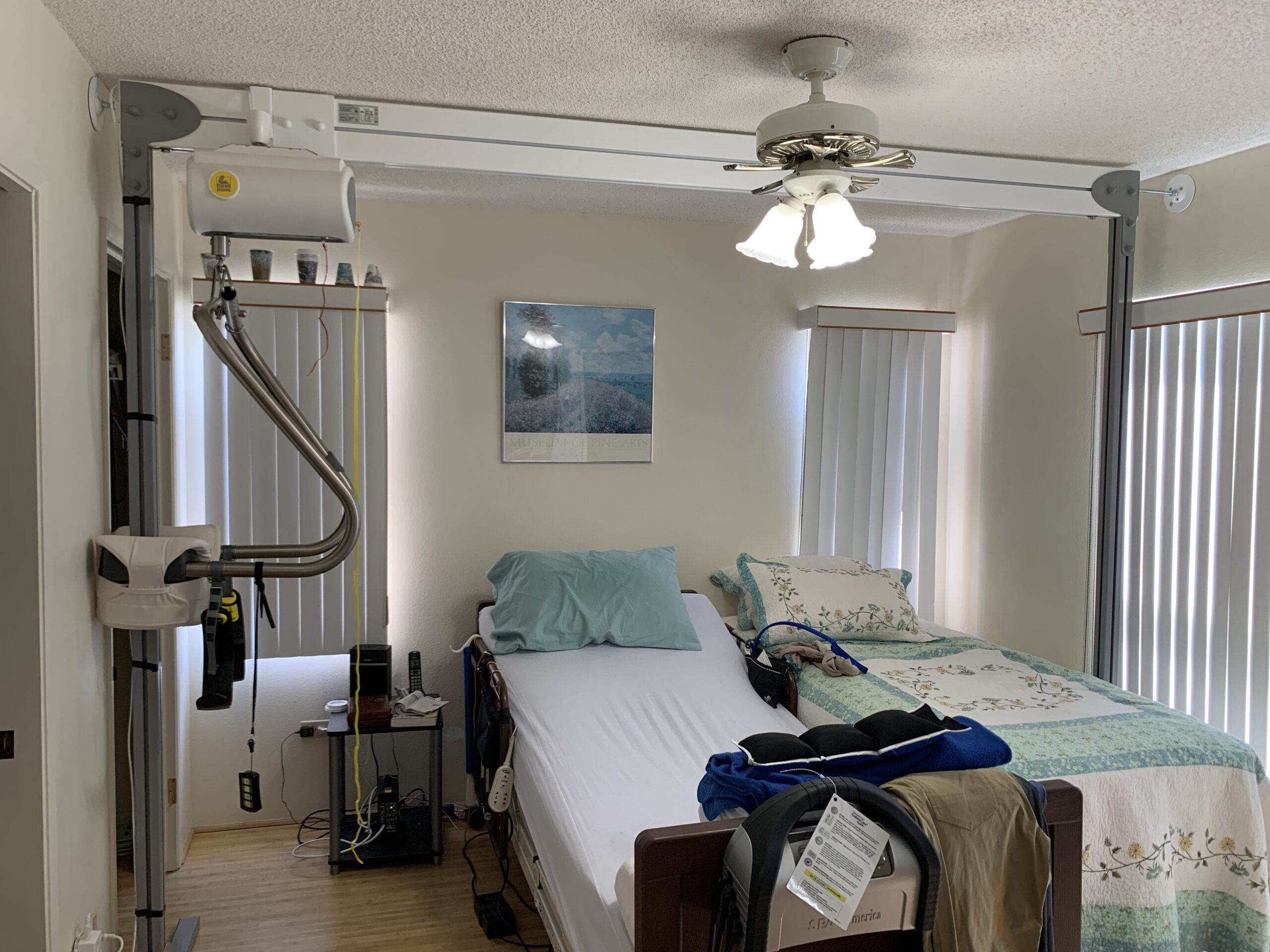 A freestanding overhead lift above the bed: after installation