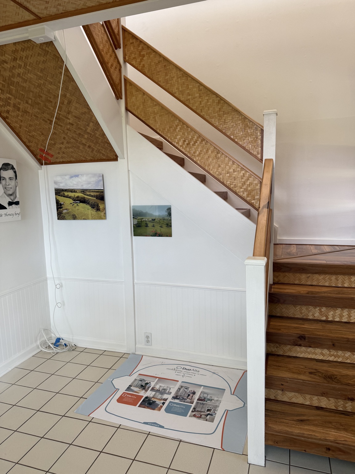 Before Stiltz installation: tiled floor and a lift footprint template beside a staircase with woven panels