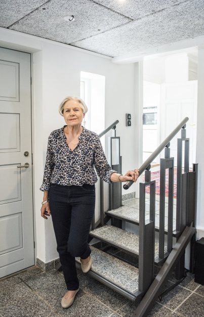 Woman using FlexStep by Liftup platform lift in residential entryway